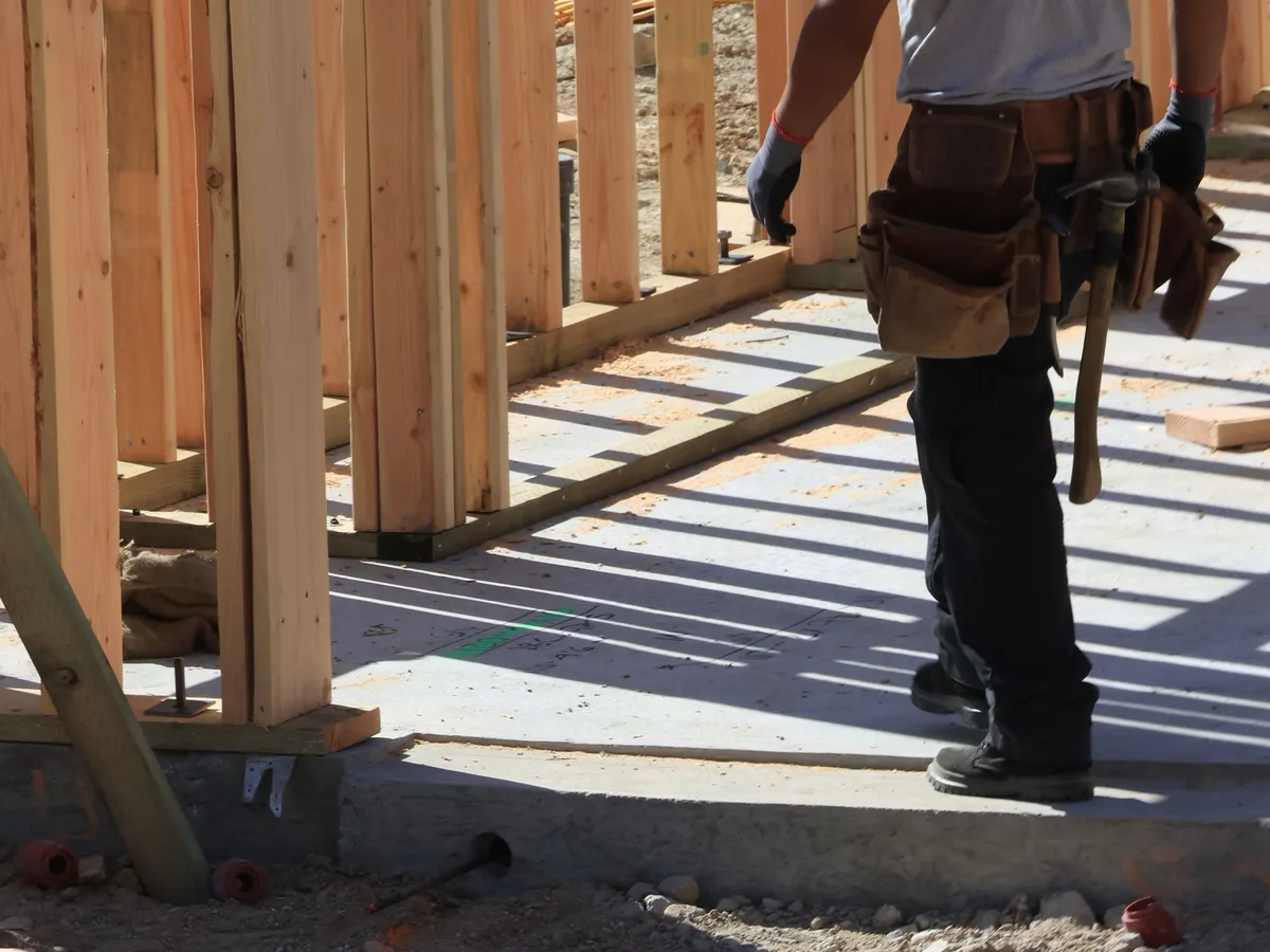 Home builder working on residential timber framing