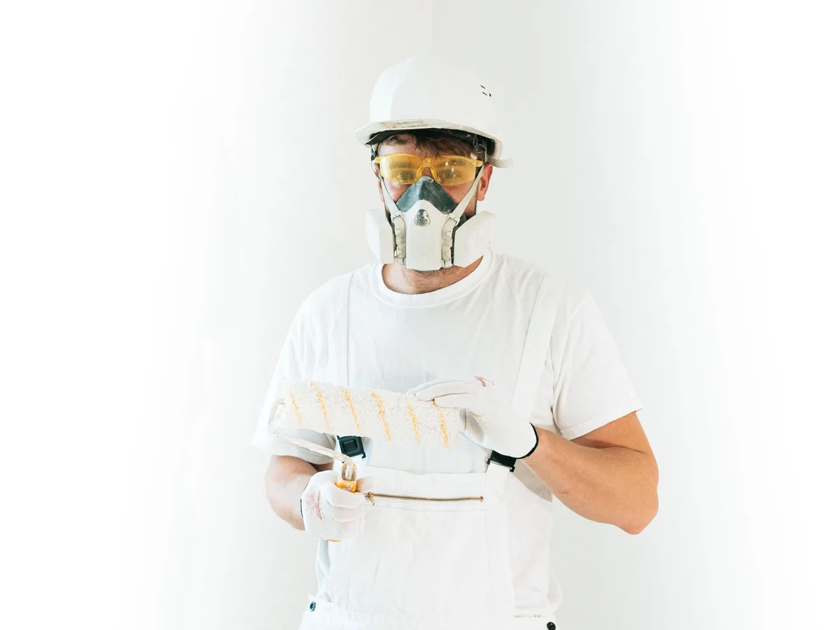 Professional painting contractor holding a paint roller